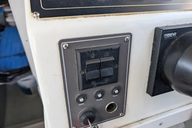 Slide: The Image of Control panel of a 1998 Cherokee 270 Sportsman boat with switches and knobs. - 36