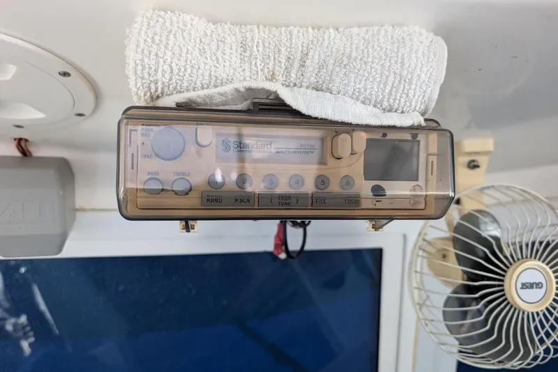 Slide: The Image of 1998 Cherokee 270 Sportsman boat interior with vintage Standard Communications radio and fan. - 39