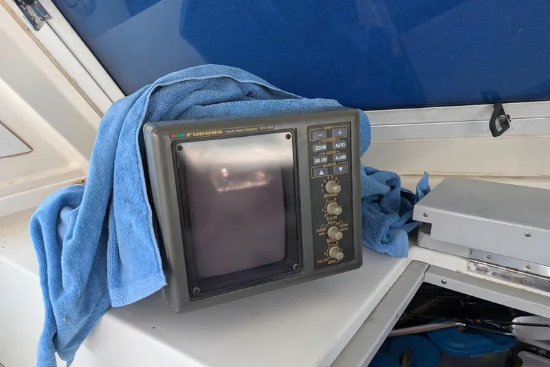 Slide: The Image of Furuno marine radar on 1998 Cherokee 270 Sportsman boat, draped with a blue towel. - 40