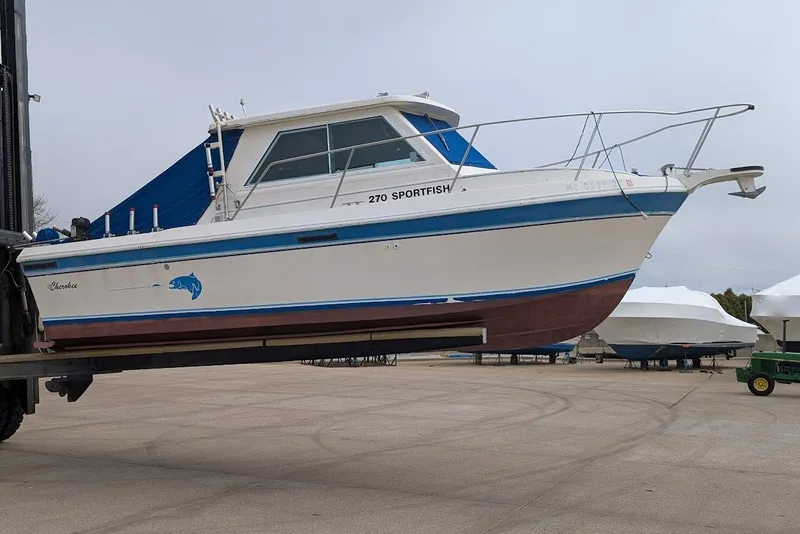 Slide: The Image of 1998 Cherokee 270 Sportsman boat on a lift, displayed outdoors. - 46
