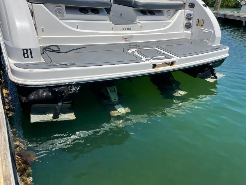 Slide: The Image of 2013 Regal 3200 Bowrider boat stern in marina, partially submerged. - 4