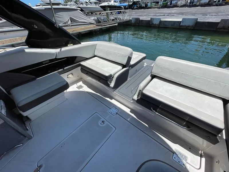 Slide: The Image of 2013 Regal 3200 Bowrider interior with spacious seating by the dock. - 5