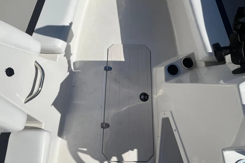 Slide: The Image of Interior view of 2025 Starcraft SVX 171 OB boat, featuring seating and storage hatch. - 11