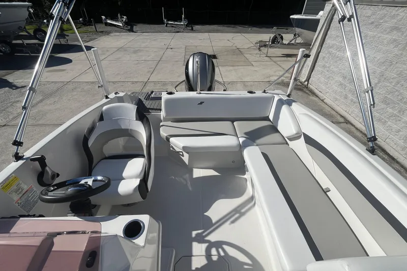 Slide: The Image of 2025 Starcraft SVX 171 OB boat interior with seating and steering wheel. - 13