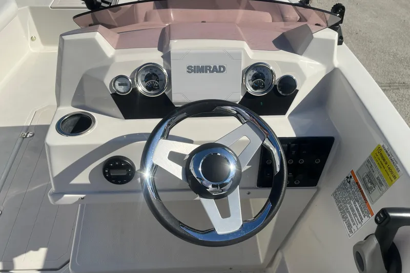 Slide: The Image of Steering console of 2025 Starcraft SVX 171 OB boat with Simrad display and gauges. - 14