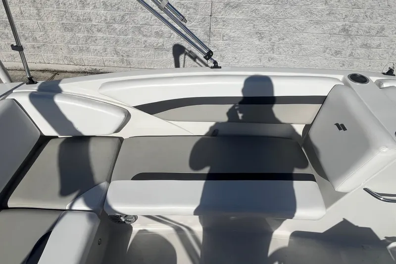 Slide: The Image of 2025 Starcraft SVX 171 OB boat interior with cushioned seating and shadow on deck. - 15