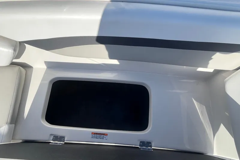 Slide: The Image of Storage compartment in 2025 Starcraft SVX 171 OB boat, featuring sleek white interior design. - 16