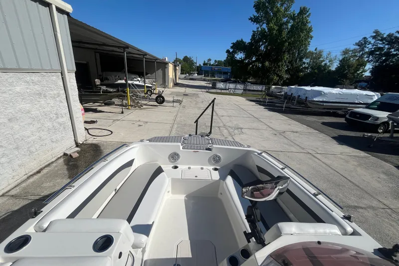 Slide: The Image of 2025 Starcraft SVX 171 OB boat interior at a marina under clear blue sky. - 2