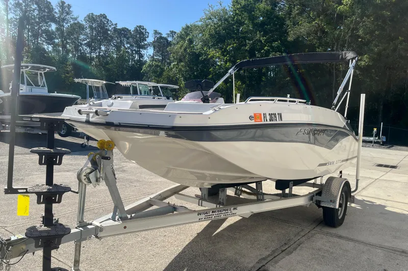 Slide: The Image of 2025 Starcraft SVX 171 OB boat on trailer in sunny outdoor setting. - 23