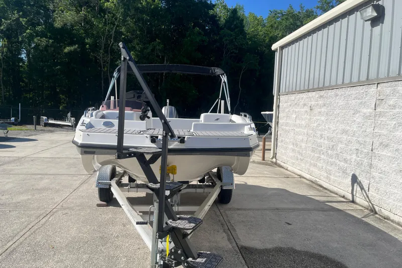 Slide: The Image of 2025 Starcraft SVX 171 OB boat on trailer, parked outdoors near a building. - 24