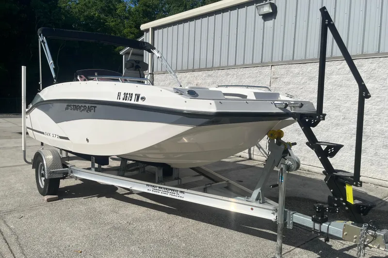 Slide: The Image of 2025 Starcraft SVX 171 OB boat on trailer, parked outdoors. - 25