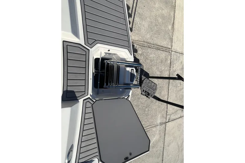 Slide: The Image of 2025 Starcraft SVX 171 OB boat deck with ladder and gray non-slip surface. - 4
