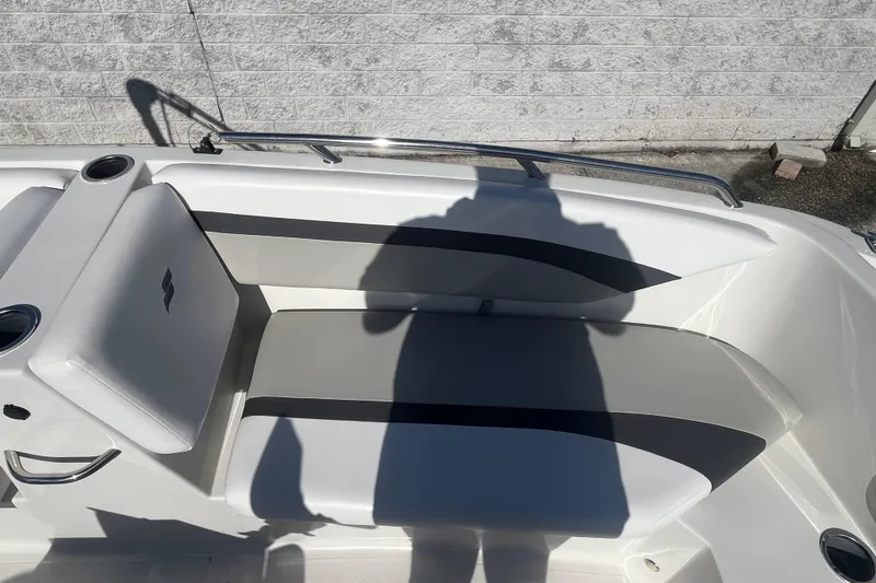 Slide: The Image of 2025 Starcraft SVX 171 OB boat interior with cushioned seating and cup holders. - 7