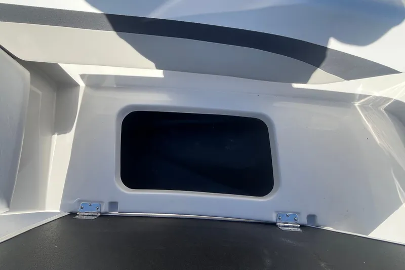 Slide: The Image of Storage compartment of 2025 Starcraft SVX 171 OB boat, featuring a hinged lid. - 8