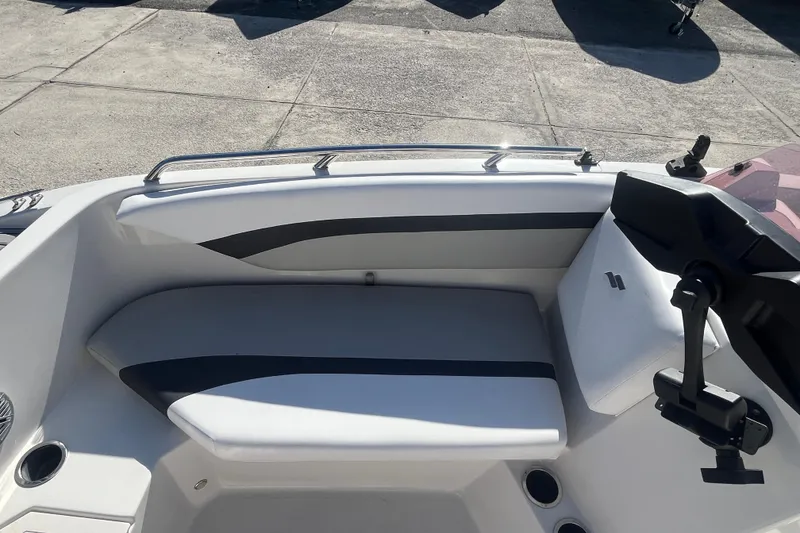 Slide: The Image of 2025 Starcraft SVX 171 OB boat interior with cushioned seating and cup holders. - 9