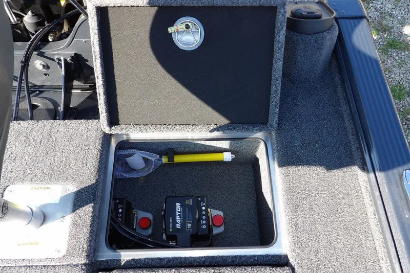 Slide: The Image of Storage compartment in 2026 Lund 2075 Pro-V Bass XS boat, featuring equipment and tools. - 13