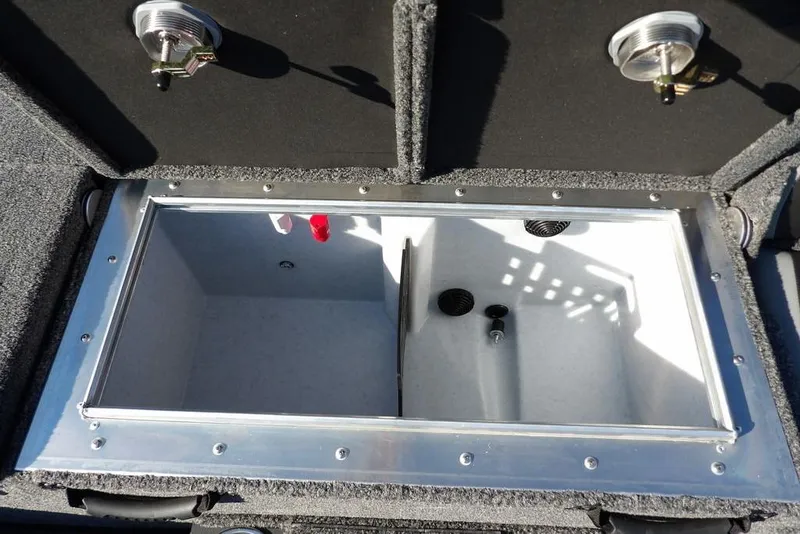 Slide: The Image of Livewell compartment in 2026 Lund 2075 Pro-V Bass XS boat, featuring secure latches and drainage system. - 14