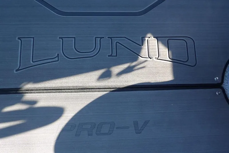 Slide: The Image of 2026 Lund 2075 Pro-V Bass XS boat deck with embossed logo. - 16