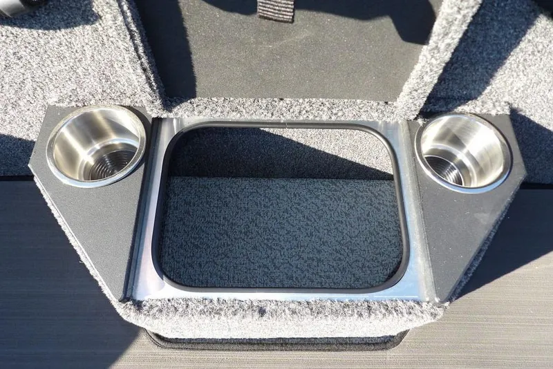 Slide: The Image of 2026 Lund 2075 Pro-V Bass XS boat interior with dual cup holders and storage compartment. - 18