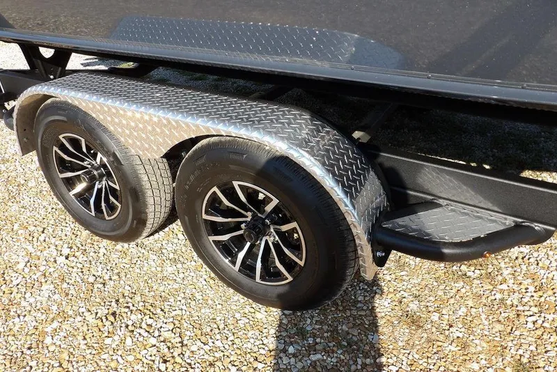 Slide: The Image of Trailer wheels of 2026 Lund 2075 Pro-V Bass XS on gravel surface. - 19