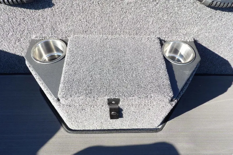 Slide: The Image of 2026 Lund 2075 Pro-V Bass XS boat interior with dual cup holders and carpeted storage. - 20