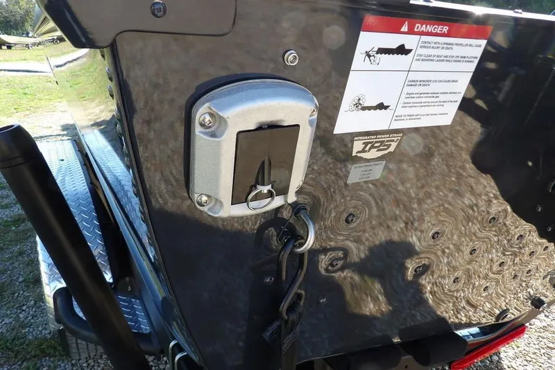 Slide: The Image of 2026 Lund 2075 Pro-V Bass XS boat with safety warning label and integrated power storage. - 25