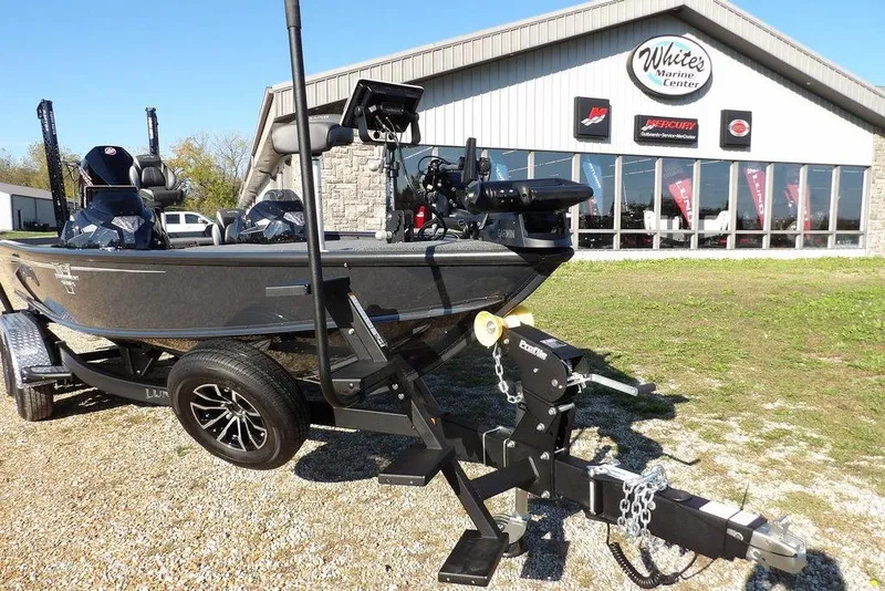 Slide: The Image of 2026 Lund 2075 Pro-V Bass XS boat on trailer outside marine center. - 30