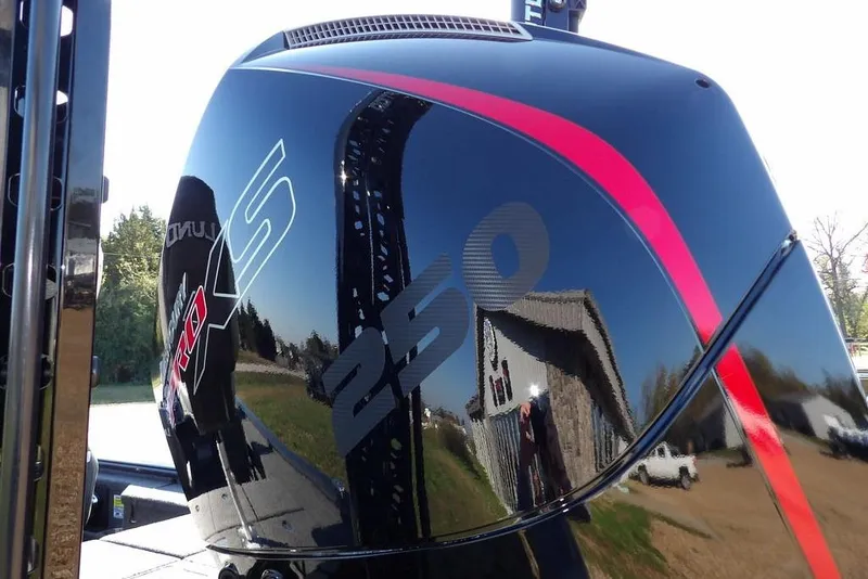 Slide: The Image of Close-up of a 2026 Lund 2075 Pro-V Bass XS boat engine with red accents. - 31