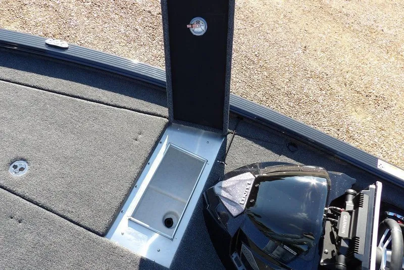 Slide: The Image of 2026 Lund 2075 Pro-V Bass XS boat interior with storage compartment and motor detail. - 37