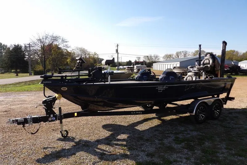 Slide: The Image of 2026 Lund 2075 Pro-V Bass XS boat on trailer, parked outdoors. - 4