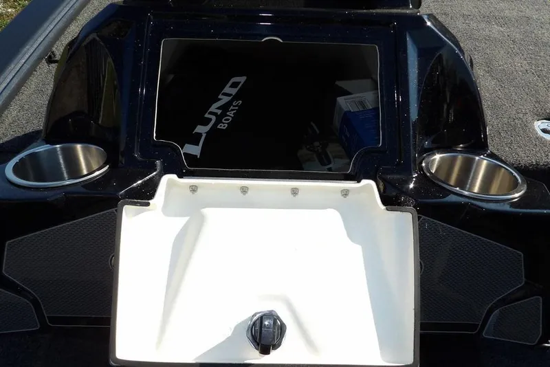 Slide: The Image of 2026 Lund 2075 Pro-V Bass XS boat interior with storage compartment and cup holders. - 46