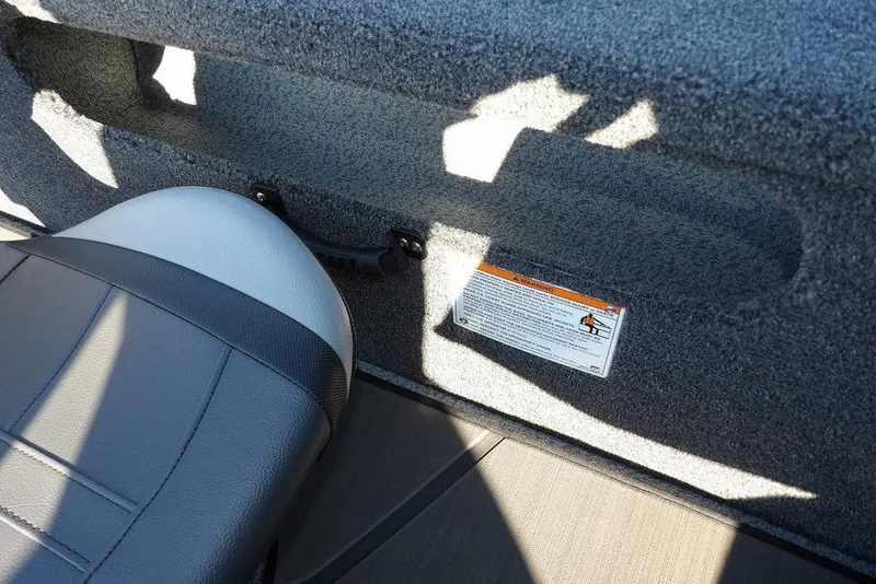 Slide: The Image of Interior of 2026 Lund 2075 Pro-V Bass XS boat with seat and safety label. - 48