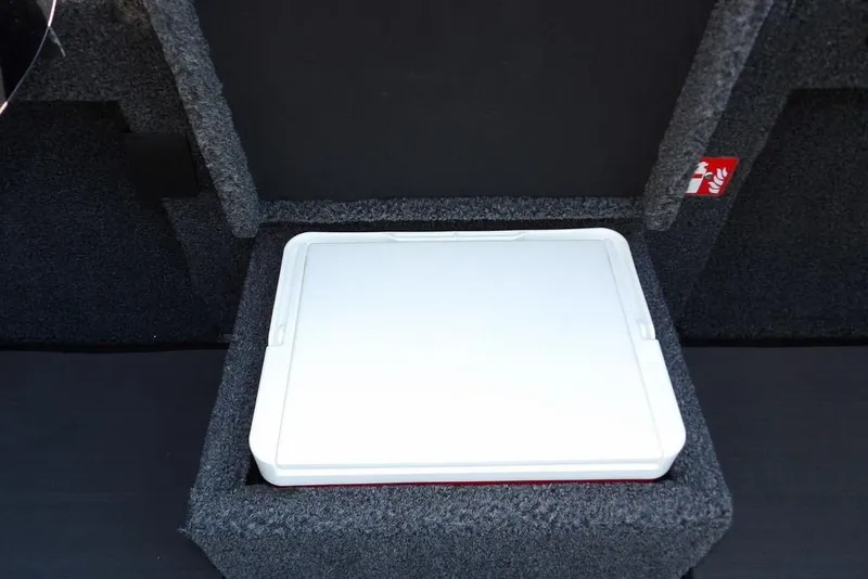 Slide: The Image of 2026 Lund 2075 Pro-V Bass XS boat storage compartment with white lid. - 60