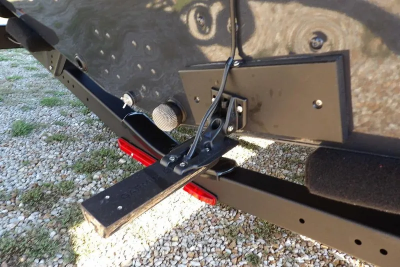 Slide: The Image of 2026 Lund 2075 Pro-V Bass XS boat trailer hitch detail on gravel surface. - 75