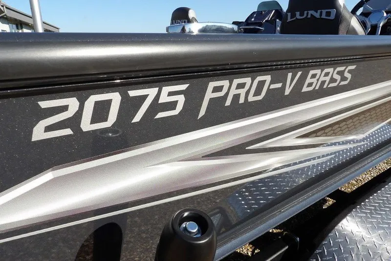 Slide: The Image of 2026 Lund 2075 Pro-V Bass XS boat, sleek design with metallic accents. - 76