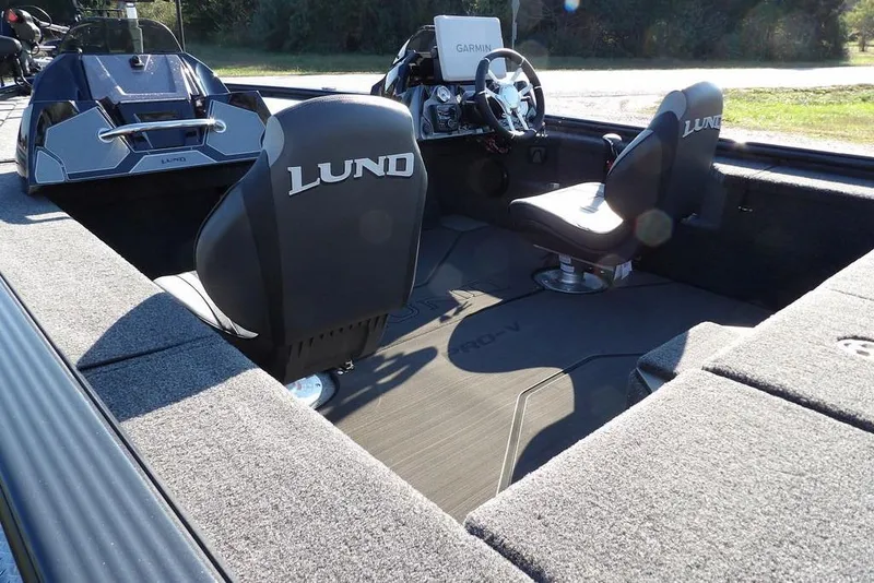 Slide: The Image of 2026 Lund 2075 Pro-V Bass XS boat interior with Garmin system and comfortable seating. - 77