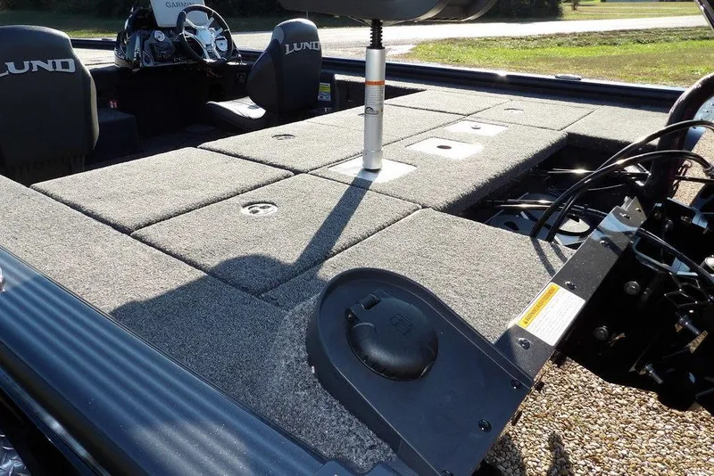 Slide: The Image of 2026 Lund 2075 Pro-V Bass XS boat interior with carpeted deck and seating. - 9