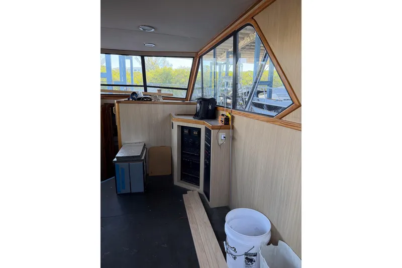 Slide: The Image of Interior of 1990 Chris-Craft 392 Commander boat with control panel and windows. - 2