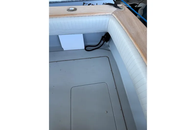 Slide: The Image of Interior view of a 1990 Chris-Craft 392 Commander boat, featuring cushioned seating and wooden trim. - 21