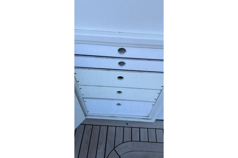 Slide: The Image of White storage drawers on a 1990 Chris-Craft 392 Commander boat deck. - 23