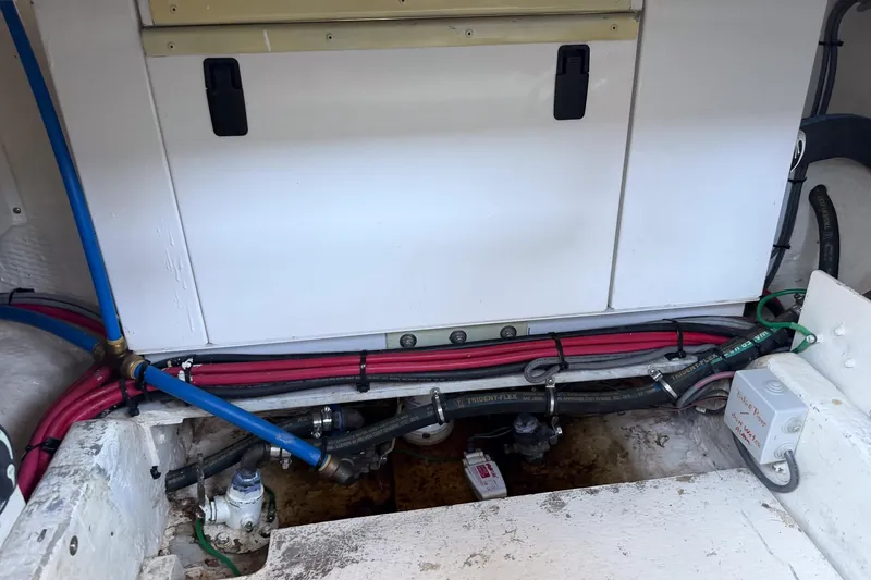 Slide: The Image of Engine compartment of 1990 Chris-Craft 392 Commander with visible hoses and wiring. - 24