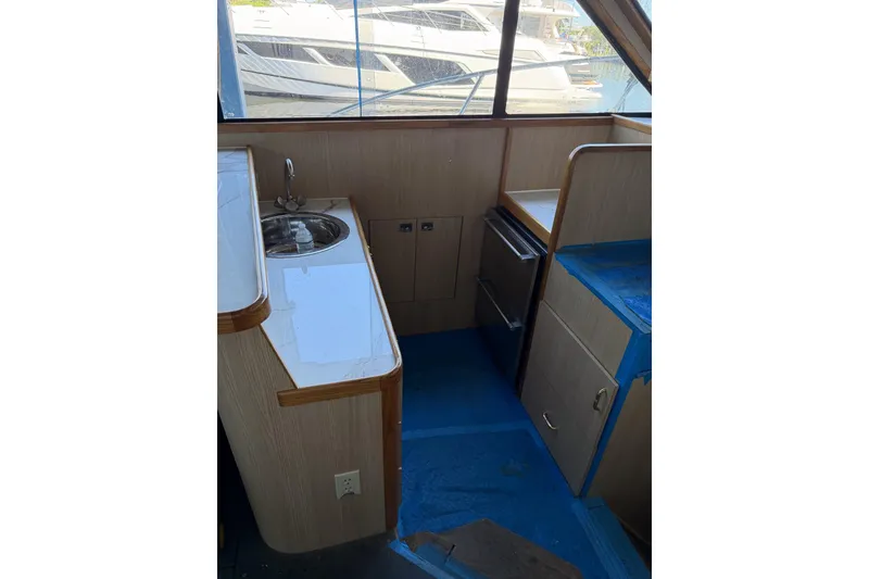 Slide: The Image of Interior of 1990 Chris-Craft 392 Commander yacht with sink and cabinetry. - 5