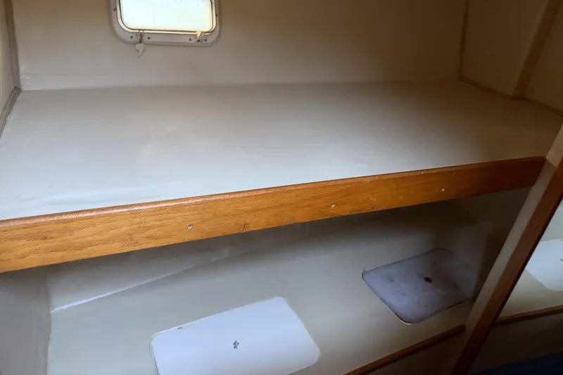 Slide: The Image of Interior cabin of 1990 Chris-Craft 392 Commander with wooden bunk and small window. - 7