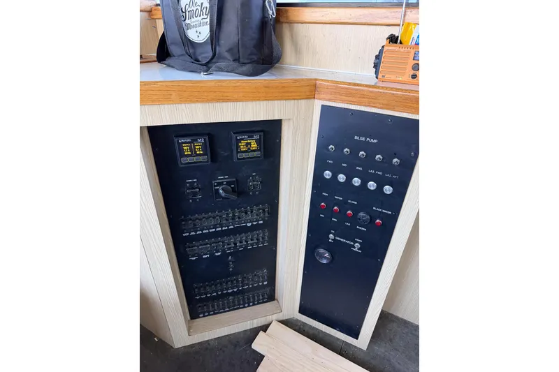 Slide: The Image of Control panel of a 1990 Chris-Craft 392 Commander boat with switches and gauges. - 9