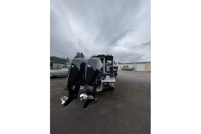 Slide: The Image of 2026 Thunder Jet 26 Alexis Pro XL boat with dual outboard motors on a cloudy day. - 3