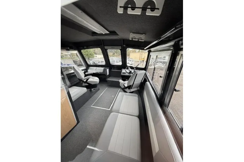 Slide: The Image of Interior of 2026 Thunder Jet 26 Alexis Pro XL boat, featuring seating and helm. - 4