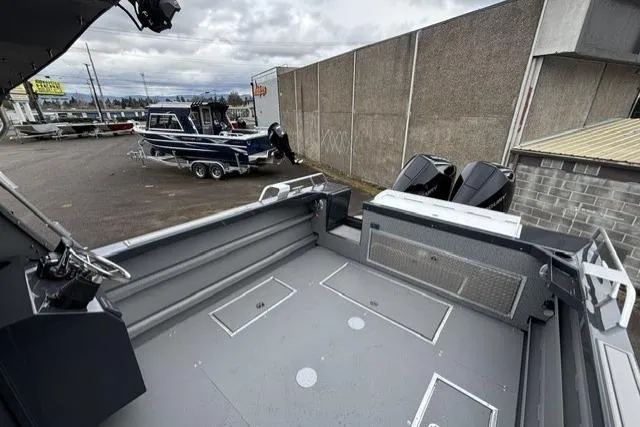 Slide: The Image of 2026 Thunder Jet 26 Alexis Pro XL boat interior with dual engines, parked outdoors. - 5