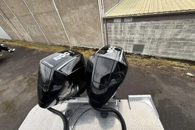 Slide: The Image of Twin black outboard motors on a Thunder Jet 26 Alexis Pro XL boat, 2026 model. - 6