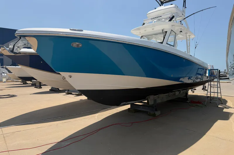 The Image of 2018 Everglades 355 Center Console boat on display in a marina setting. - 0