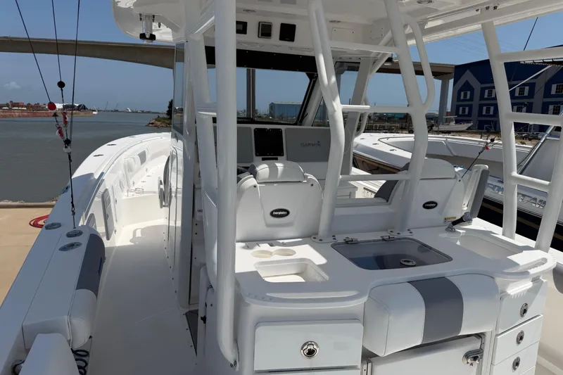 Slide: The Image of 2018 Everglades 355 Center Console boat docked, featuring spacious deck and modern amenities. - 12